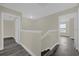 Upstairs hallway with wood-look flooring and white trim and doors at 3778 Martin St, Orlando, FL 32806