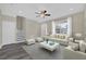 Bright living room with a ceiling fan, a gray rug and a matching comfy white sofa and side chairs at 3778 Martin St, Orlando, FL 32806