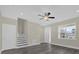 Inviting living room with stairs, ceiling fan, and ample light, with dark wood-look flooring throughout at 3778 Martin St, Orlando, FL 32806