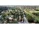 Aerial view of a suburban neighborhood with lush trees, a golf course, and a glimpse of the lake at 400 W Par St, Orlando, FL 32804