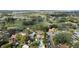 Aerial view of neighborhood featuring a pool, and a golf course with serene lakes in the background at 400 W Par St, Orlando, FL 32804