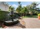 Serene backyard with stone fountain, manicured hedges, and lush landscaping at 400 W Par St, Orlando, FL 32804