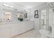 Elegant bathroom featuring double vanities, marble countertops, and a glass-enclosed shower with tile surround at 400 W Par St, Orlando, FL 32804