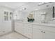 Elegant bathroom featuring double vanities, marble countertops, and a glass-enclosed shower with tile surround at 400 W Par St, Orlando, FL 32804