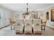 Sophisticated dining room featuring glass table, chandelier, and stylish chairs in a brightly lit space at 400 W Par St, Orlando, FL 32804