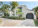 Elegant white stucco home features a gated entrance, lush landscaping, and a striking blue accent window at 400 W Par St, Orlando, FL 32804