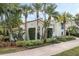 Stunning Mediterranean-style home with lush tropical landscaping and a red tile roof, creating a private oasis at 400 W Par St, Orlando, FL 32804