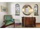 Beautiful foyer with unique architectural details, arched windows, and a vintage chair and dresser at 400 W Par St, Orlando, FL 32804