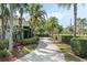 Long driveway bordered by lush greenery leading to an elegant home with a meticulously maintained yard at 400 W Par St, Orlando, FL 32804