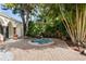 Charming courtyard featuring a tranquil hot tub with stone accents and lush tropical greenery for a serene escape at 400 W Par St, Orlando, FL 32804