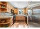 Well-lit kitchen with stainless steel refrigerator, natural wood cabinets, and modern black appliances at 400 W Par St, Orlando, FL 32804