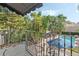 Lush backyard view from balcony with a pool, lounge seating, and vibrant foliage at 400 W Par St, Orlando, FL 32804