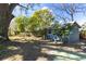 Spacious backyard features mature trees and a charming shed at 403 Louis St, Leesburg, FL 34748