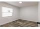 Well-lit bedroom with sleek wood-look floors and ample natural light at 403 Louis St, Leesburg, FL 34748