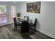 Cozy dining area featuring a round table with black chairs and doors to outdoor patio at 403 Louis St, Leesburg, FL 34748