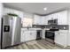 Bright, renovated kitchen with modern stainless steel appliances, sleek countertops, and stylish gray backsplash at 403 Louis St, Leesburg, FL 34748