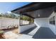 Covered patio with white brick walls, a sleek gray floor, and a view of the fenced backyard at 403 Louis St, Leesburg, FL 34748