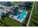 Aerial view of community pool, lounge area, clubhouse, and lush landscaping at 4294 Campsite Loop, Orlando, FL 32824