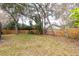 The backyard features lush grass, mature trees, and a privacy fence at 4309 Enright Ct, Winter Park, FL 32792