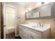 This bathroom features a double sink with modern fixtures, white cabinets, and a large, framed mirror at 4309 Enright Ct, Winter Park, FL 32792