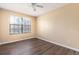 This bedroom features modern flooring, natural light from the large window, and a ceiling fan at 4309 Enright Ct, Winter Park, FL 32792