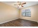 This bedroom features modern flooring, natural light from the large window, and a ceiling fan at 4309 Enright Ct, Winter Park, FL 32792