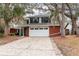 A charming two-story home with a red brick facade, a two-car garage, and mature trees at 4309 Enright Ct, Winter Park, FL 32792