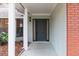 Inviting front porch leading to a well-maintained home with a classic brick accent wall at 4309 Enright Ct, Winter Park, FL 32792