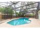 This backyard features a sparkling in-ground pool, a screened enclosure, and a rock garden at 4309 Enright Ct, Winter Park, FL 32792