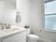 Bathroom featuring a single sink vanity, white cabinets, and a window with privacy glass at 431 Scotsmans Pl, Debary, FL 32713