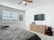 This bedroom features a ceiling fan, carpeted floors, and a dresser with a TV at 431 Scotsmans Pl, Debary, FL 32713