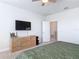 This bedroom features a ceiling fan, carpeted floors, and a dresser with a TV at 431 Scotsmans Pl, Debary, FL 32713