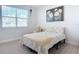 Bedroom featuring a cozy bed, neutral colors, and a window offering natural light at 431 Scotsmans Pl, Debary, FL 32713