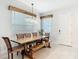 Dining area with wooden table, bench seating, and natural lighting at 431 Scotsmans Pl, Debary, FL 32713