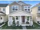 Two-story home featuring a covered front porch with chairs and table at 431 Scotsmans Pl, Debary, FL 32713