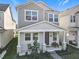 Two-story home featuring a covered front porch with chairs and table at 431 Scotsmans Pl, Debary, FL 32713