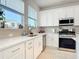 Kitchen featuring white cabinets, stainless steel appliances, quartz countertops and a view at 431 Scotsmans Pl, Debary, FL 32713