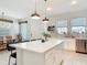 Bright kitchen features a spacious island with quartz countertops, stainless steel appliances, and pendant lighting at 431 Scotsmans Pl, Debary, FL 32713