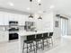 Kitchen island with bar seating, stainless appliances, and quartz countertops at 431 Scotsmans Pl, Debary, FL 32713