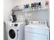 Laundry room featuring a front loading washer and dryer, with wire shelving for storage at 431 Scotsmans Pl, Debary, FL 32713