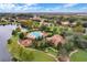 Aerial view of a community with a lake, swimming pool, and community park surrounded by well-maintained homes at 448 Douglas Edward Dr, Ocoee, FL 34761