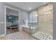 Stylish bathroom featuring a soaking tub, glass-enclosed shower, and patterned tile flooring with an open view to the main bedroom at 448 Douglas Edward Dr, Ocoee, FL 34761