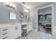 Bathroom featuring dual vanity sinks, modern fixtures, and patterned tile flooring with an open view to the main bedroom at 448 Douglas Edward Dr, Ocoee, FL 34761