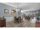 Stylish dining area adjacent to the living room, complete with modern chandelier, and decorative wainscoting at 448 Douglas Edward Dr, Ocoee, FL 34761