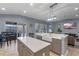 Kitchen featuring an island, stainless steel appliances, and a view of the outdoor pool area at 448 Douglas Edward Dr, Ocoee, FL 34761