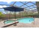 Inviting screened-in pool area with spa, lush landscaping, and a spacious patio perfect for outdoor entertaining at 448 Douglas Edward Dr, Ocoee, FL 34761