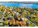 Beautiful aerial shot of a house nestled among trees and facing a lake at 465 Mandalay Rd, Orlando, FL 32809