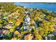 Stunning aerial view of a waterfront home with lush landscaping and boat dock access to the lake at 465 Mandalay Rd, Orlando, FL 32809