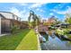 A beautiful view of the canal, backyard, boat lift, and dock of this waterfront property at 465 Mandalay Rd, Orlando, FL 32809