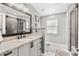 Bathroom features a granite vanity with a black faucet and a shower with a glass door at 465 Mandalay Rd, Orlando, FL 32809